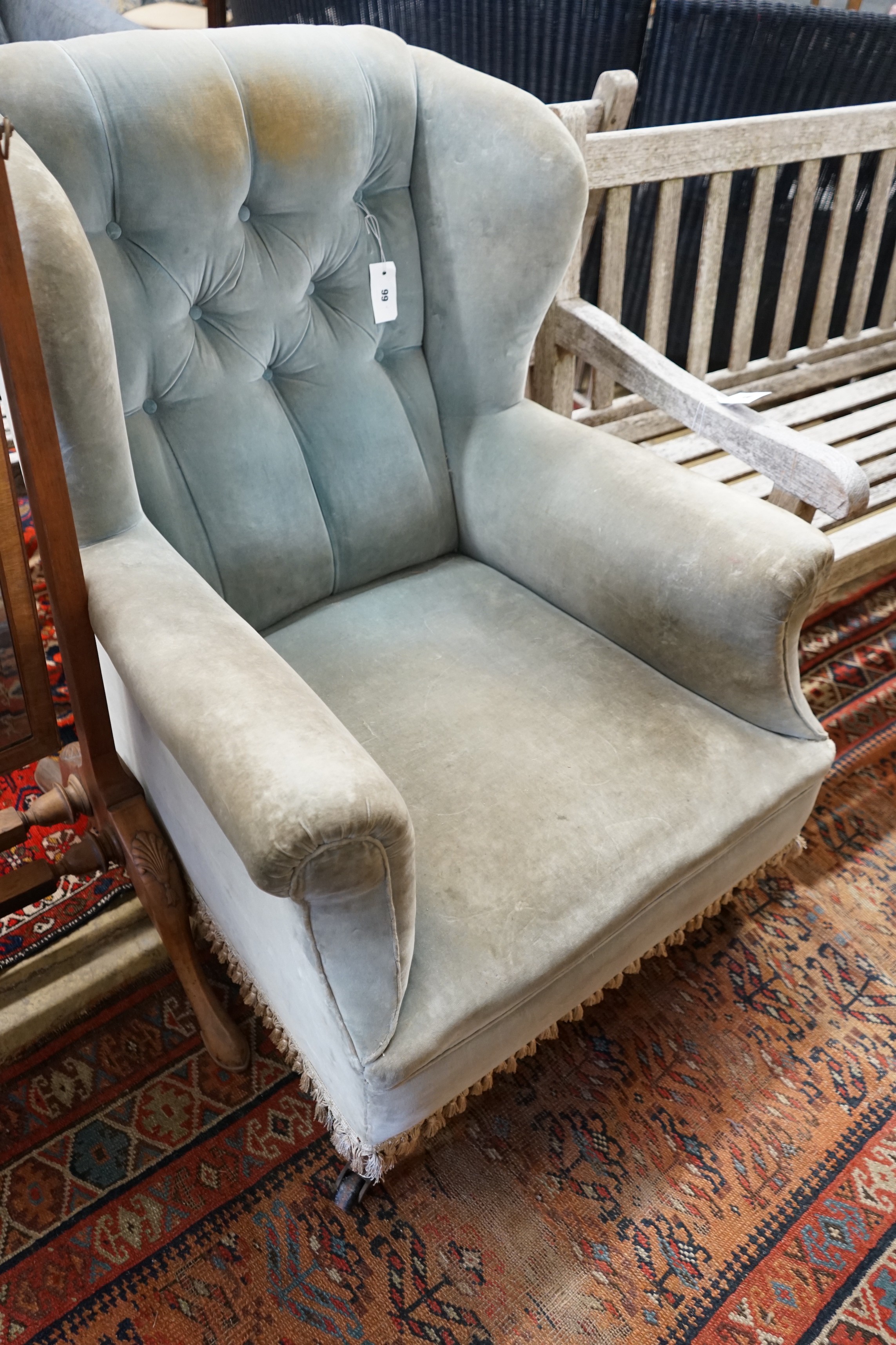 A late Victorian upholstered wing armchair, width 76cm, depth 82cm, height 90cm